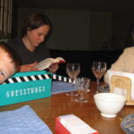 Family playing board game at dinner table.