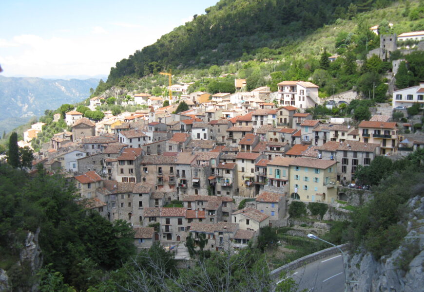 Hillside village with clustered stone houses.