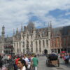 Historic city square with people and buildings.