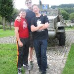 Alex, Kevin and David in front of a half track in a small Belgian village.