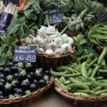 Market display of fresh vegetables in baskets.