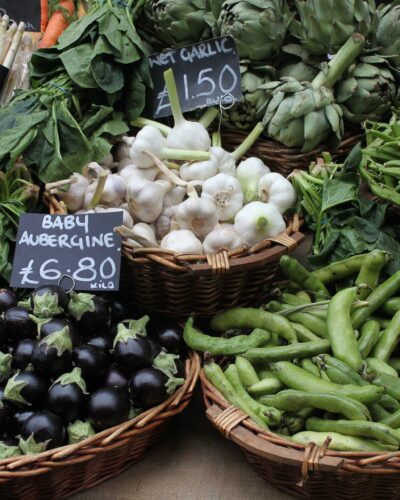Market display of fresh vegetables in baskets.