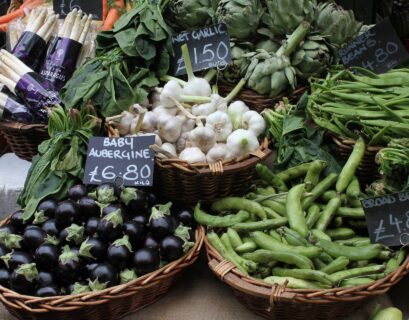 Market display of fresh vegetables in baskets.