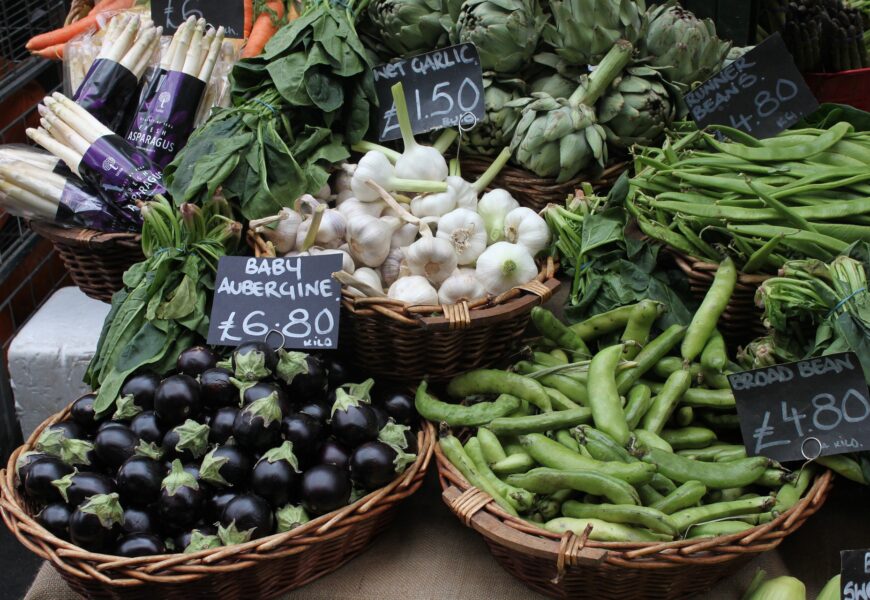 Market display of fresh vegetables in baskets.
